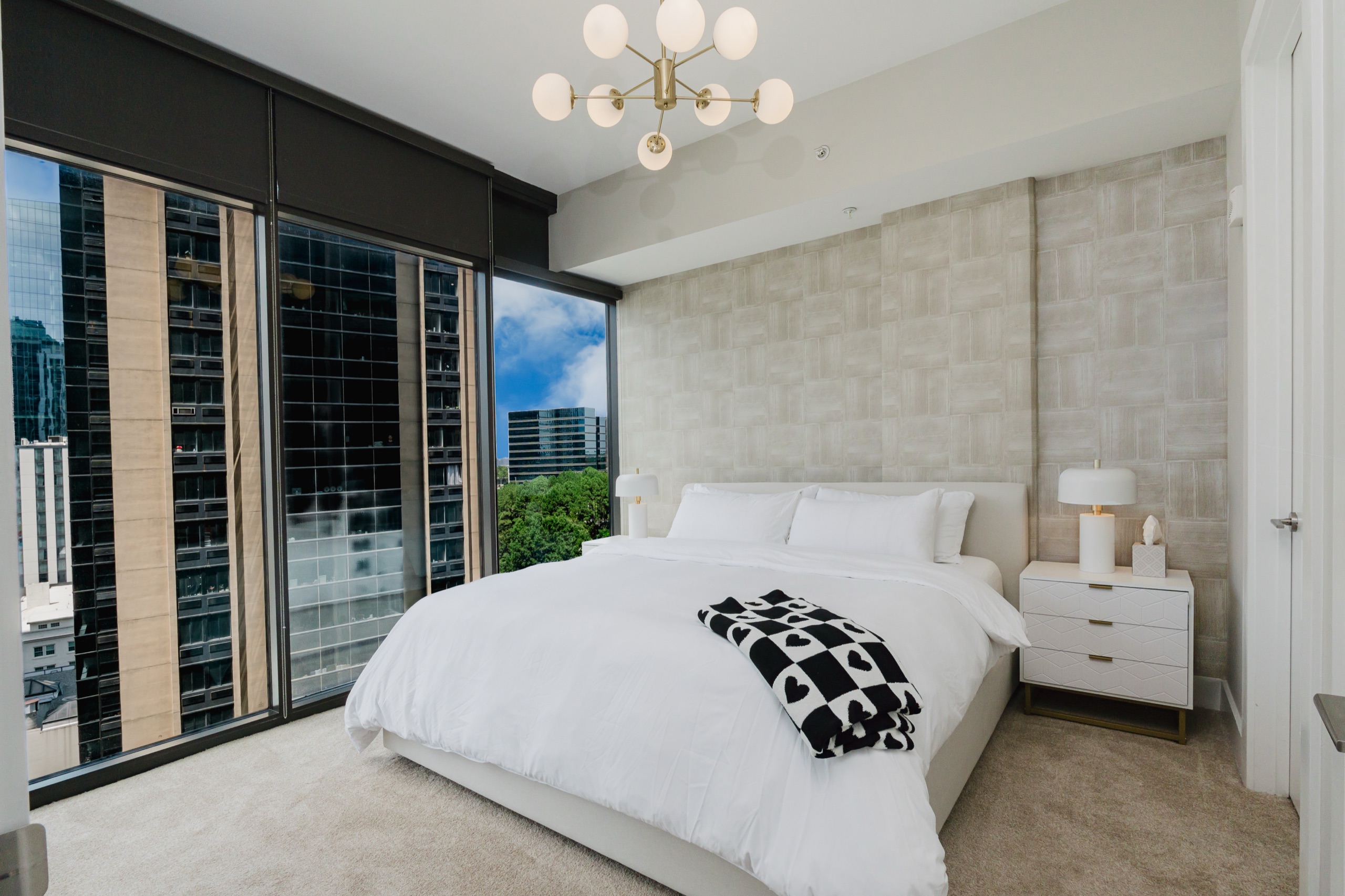 High rise condo bedroom with skyline views over Atlanta